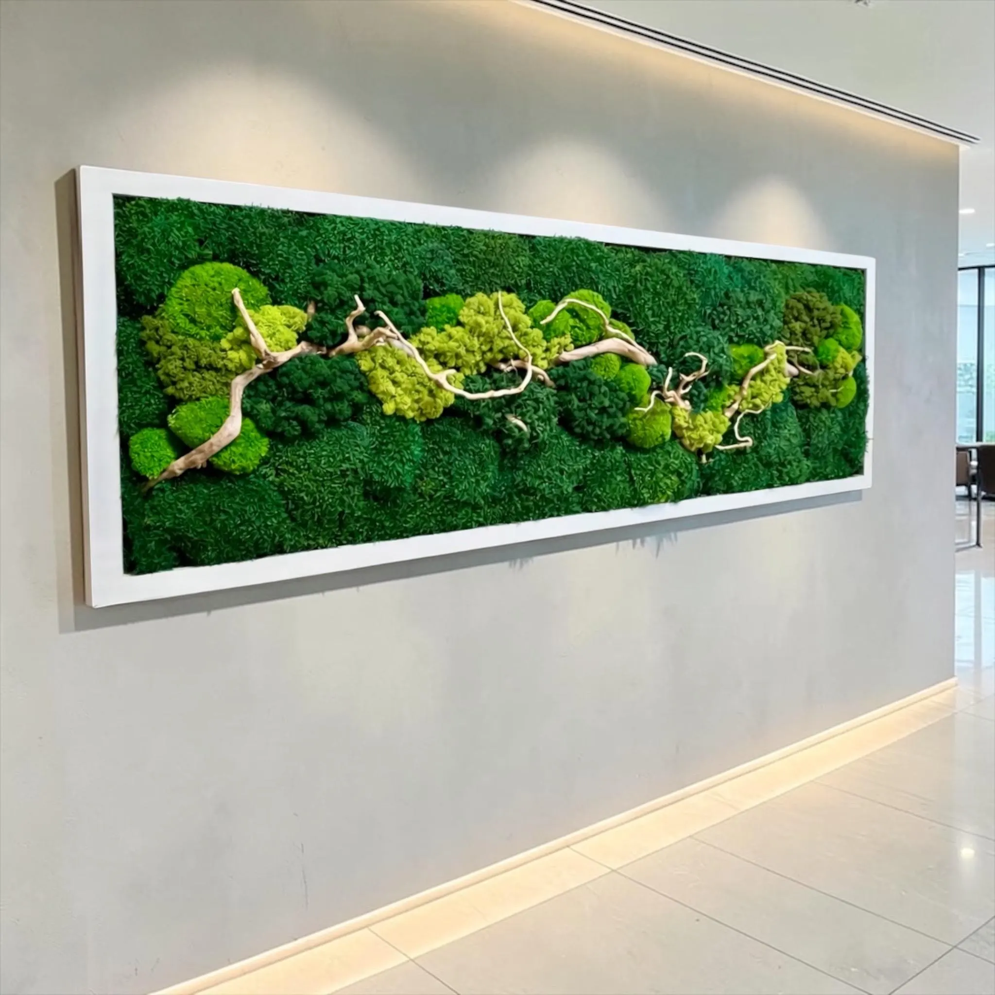 Nature-inspired wall decor with layered moss textures and botanical accents framed in natural wood.